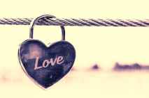 close up of padlocks hanging on heart shape